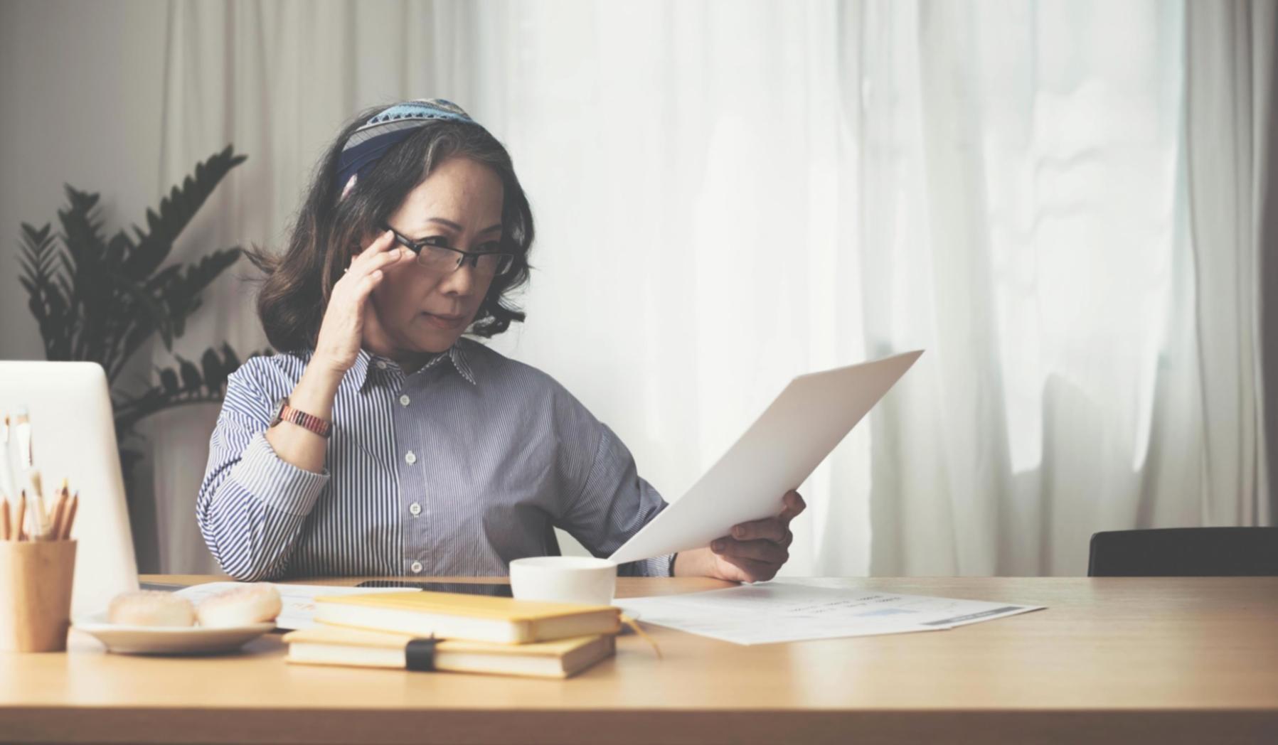 Professional financial consultation workspace with documents and calculator, representing our personalized approach to budget consolidation